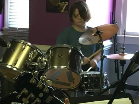 a person playing a drum set