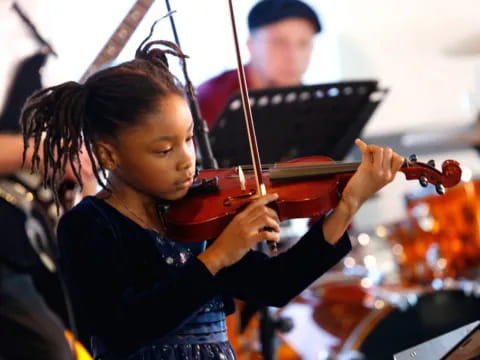 a girl playing a violin