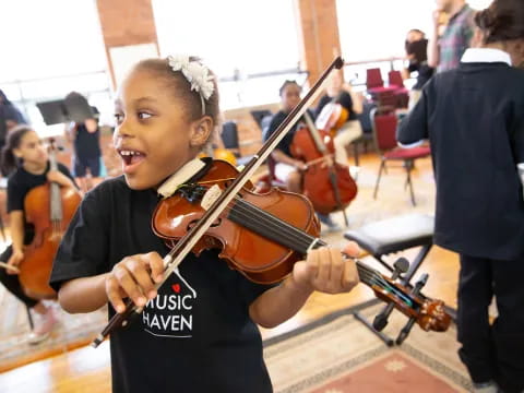 a girl playing a violin