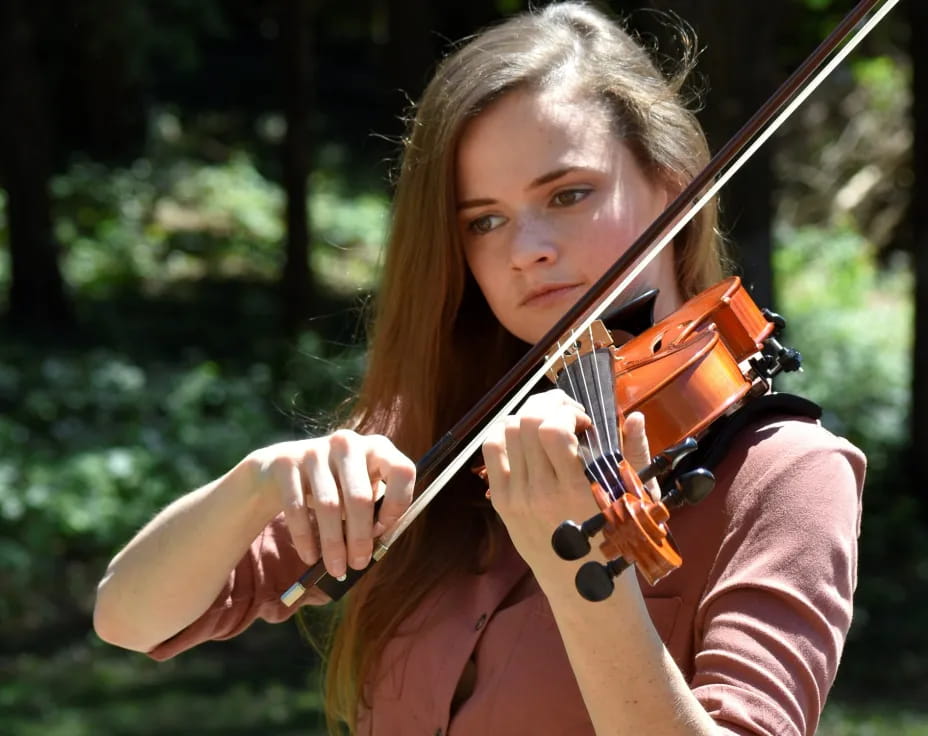 a woman playing a violin