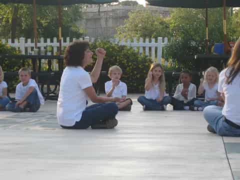 a group of people sitting on the ground