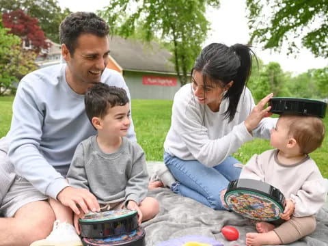 a family sitting on the grass