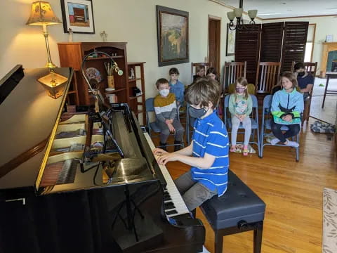 a group of kids playing piano