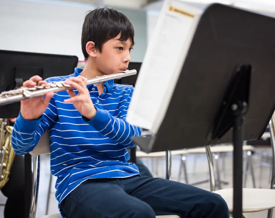 a boy playing a flute