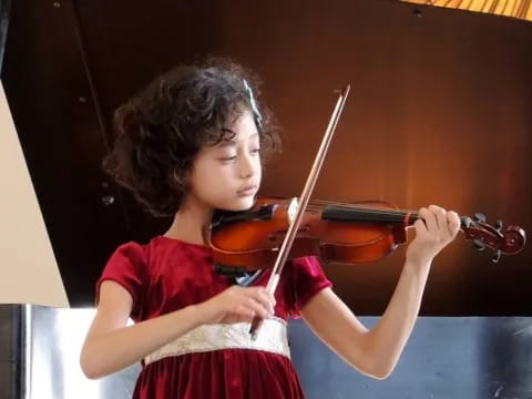 a girl playing a violin