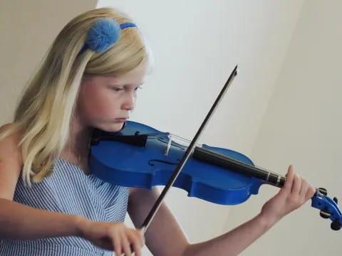 a woman playing a violin