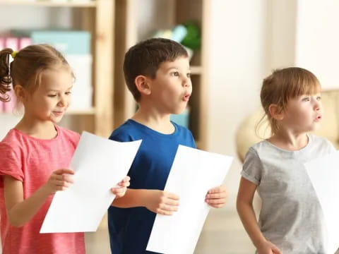 a group of children holding papers