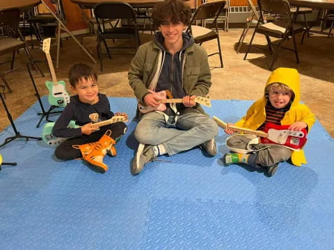 a group of kids sitting on the floor with toys