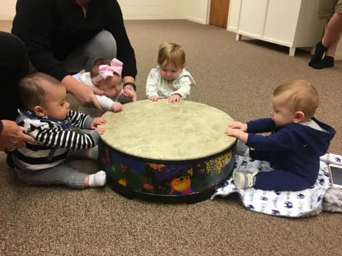 a group of children around a cake