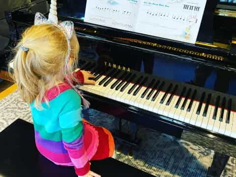 a girl playing a piano