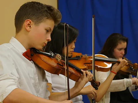 a group of kids playing violin