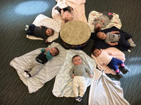 a group of babies lying on the floor