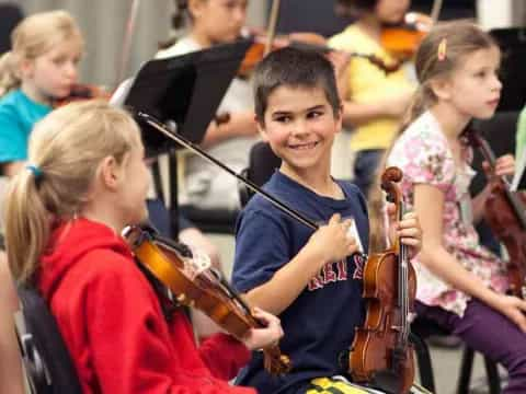 a boy playing a violin