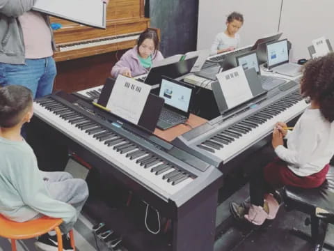 a group of people playing piano