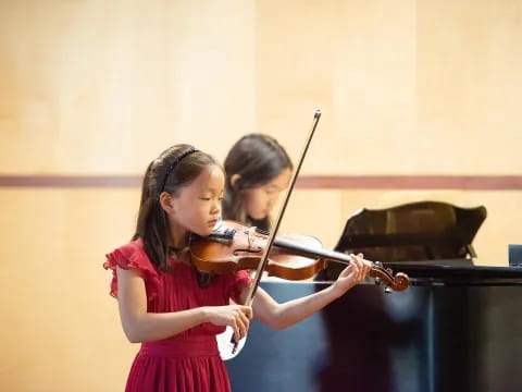 a couple of girls playing violin