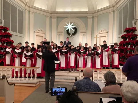 a person standing in front of a group of people in a church