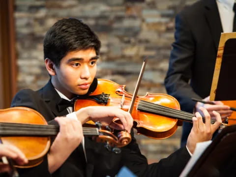 a boy playing a violin