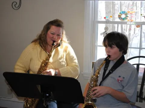 a woman and a boy playing instruments