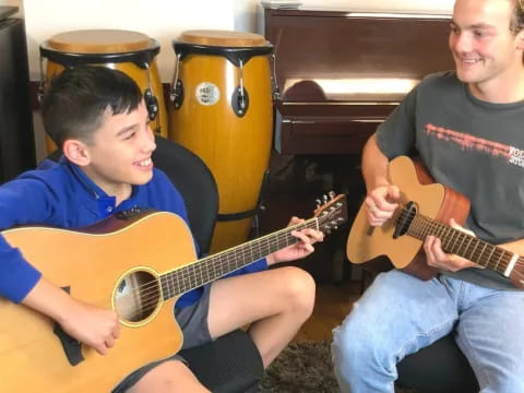 a man and a woman playing guitars