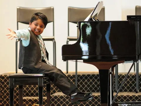 a boy playing a piano