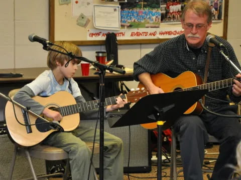 a couple of men playing guitars