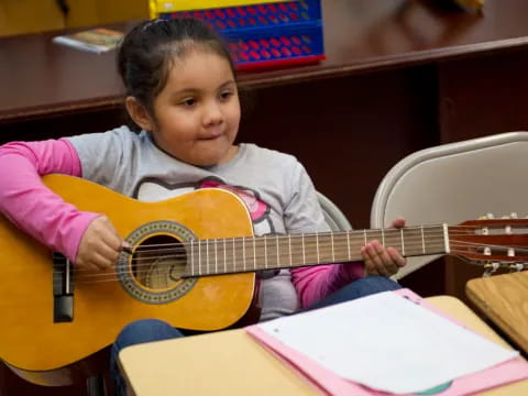 a child playing a guitar