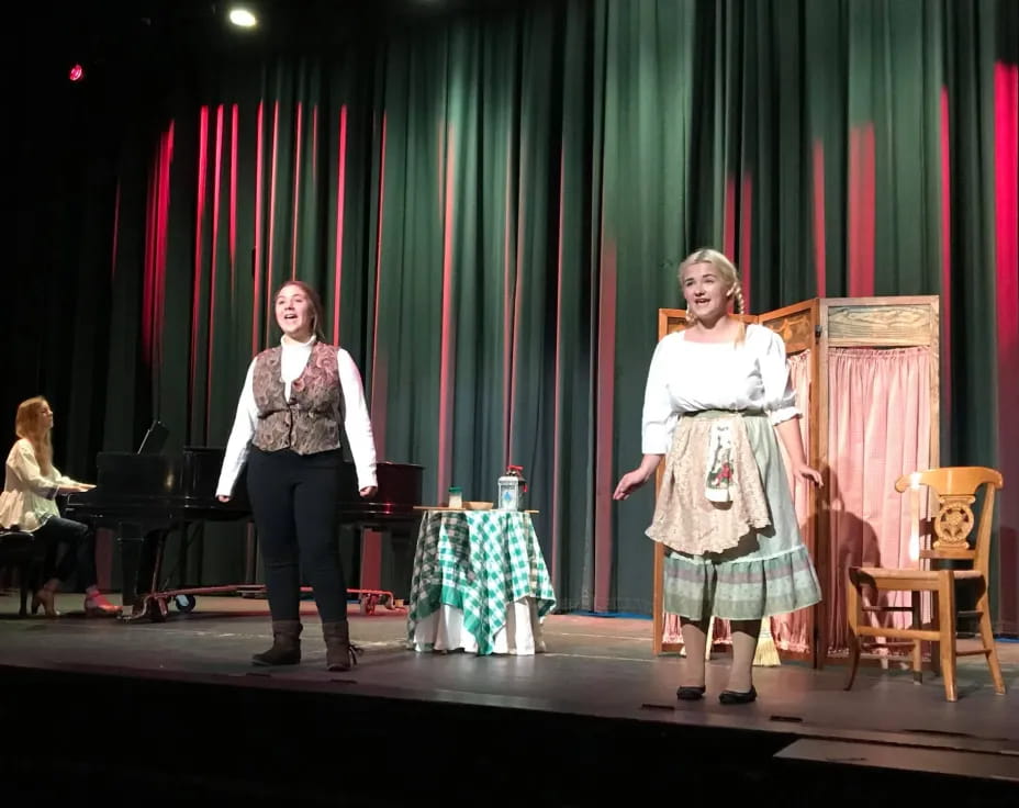 a couple of women on a stage