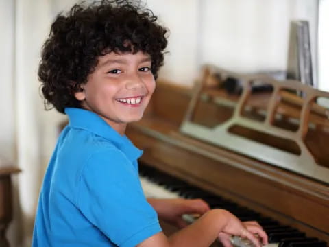 a boy playing a piano