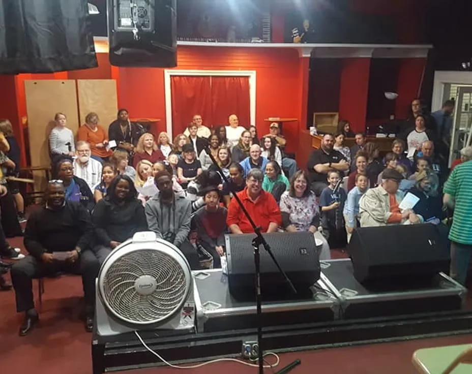 a group of people sitting on a stage