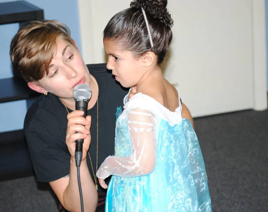 a boy and girl holding a microphone