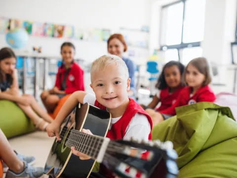 a group of children sitting in a classroom