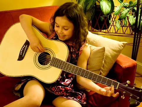 a girl playing a guitar