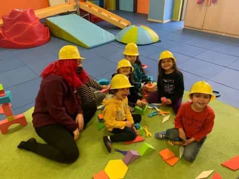 a group of children wearing yellow hats