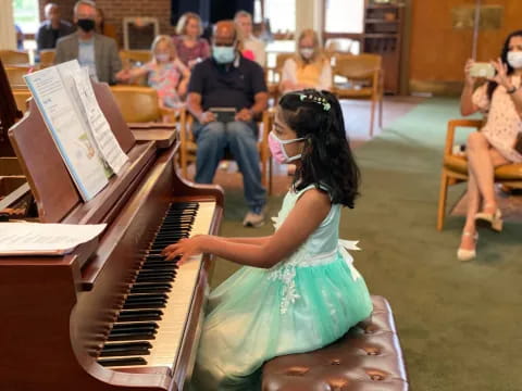 a girl playing a piano