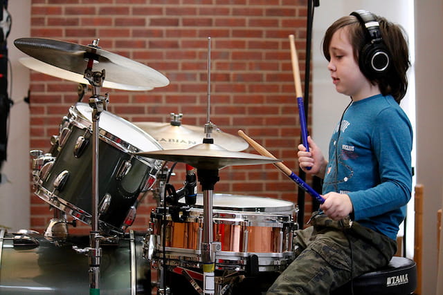a young boy playing drums