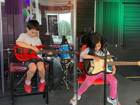 a couple of kids playing guitars