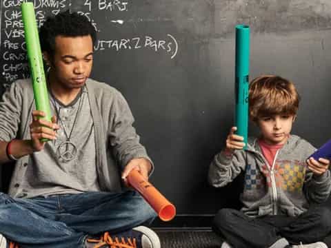 a man and a boy holding baseball bats