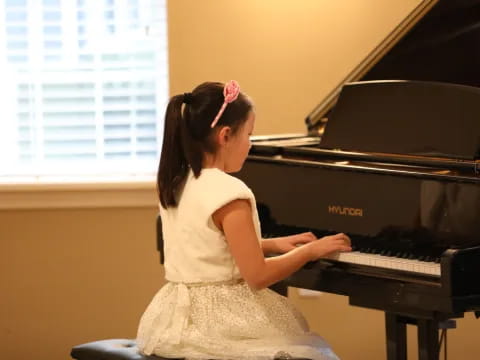 a girl playing a piano