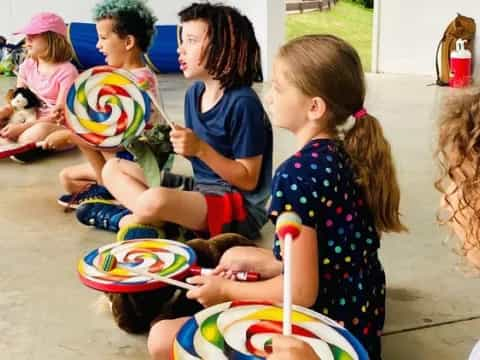 a group of children sitting on the ground