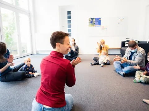 a woman talking to a group of children in a room