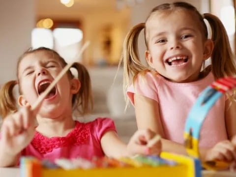 a couple of young girls playing with toys