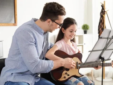 a man and a woman playing guitar