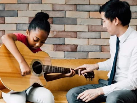 a man and a woman playing guitar