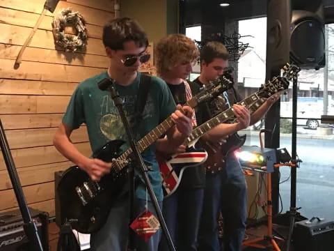 a group of men playing guitars