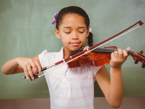 a girl playing a violin