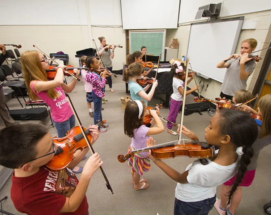 a group of children playing instruments