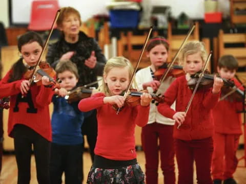 a group of kids playing instruments