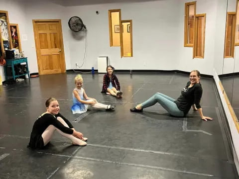 a group of women sitting on the floor