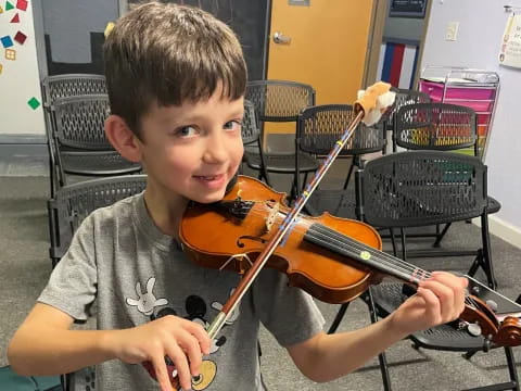 a boy holding a violin