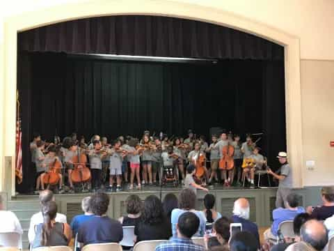 a group of people performing on stage